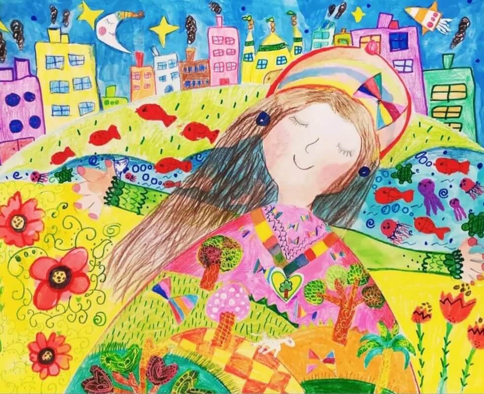 Child drawing by representing Mother Earth smiling. She has a green hill full of trees and flowers as her body, and a rainbow over her head. In the background are houses.