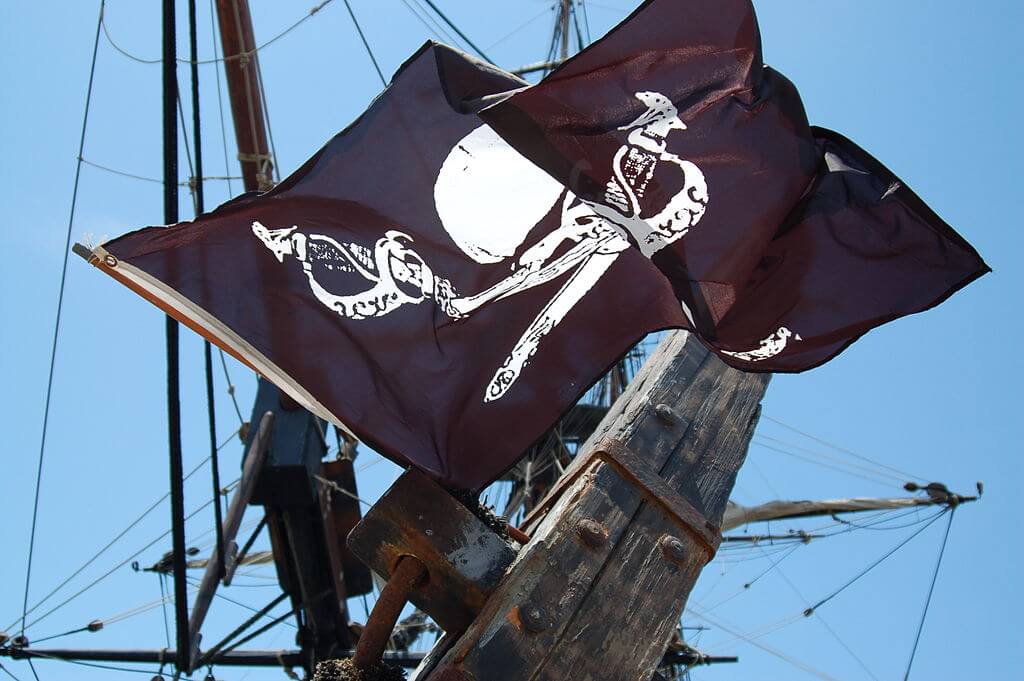 Photograph of the Jolly Roger flag in the wind.