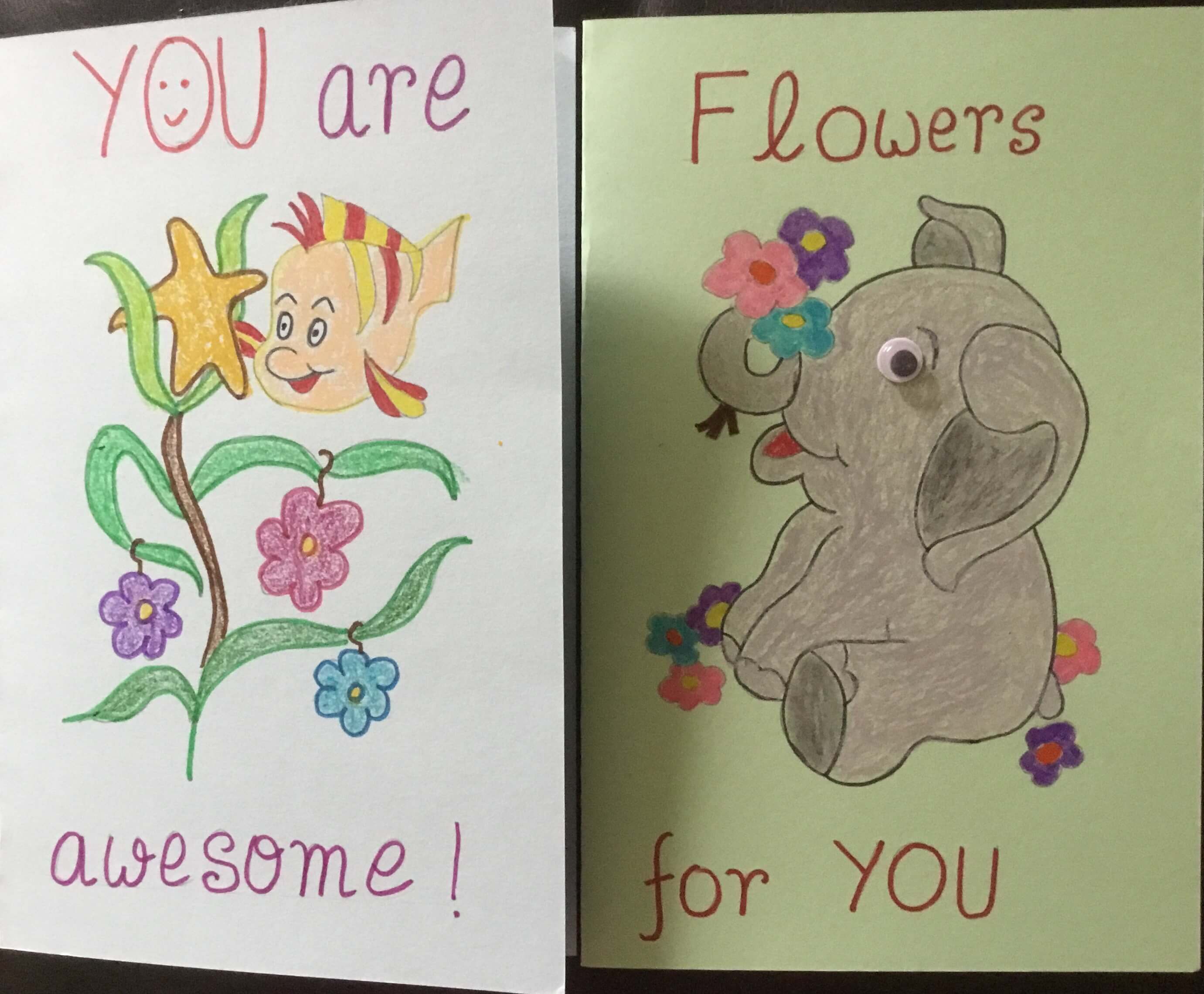 Photograph of two cards, one with a fish and the message: You are awesome, and the other with an elephant surrounded by flowers, and the message: Flowers for you.