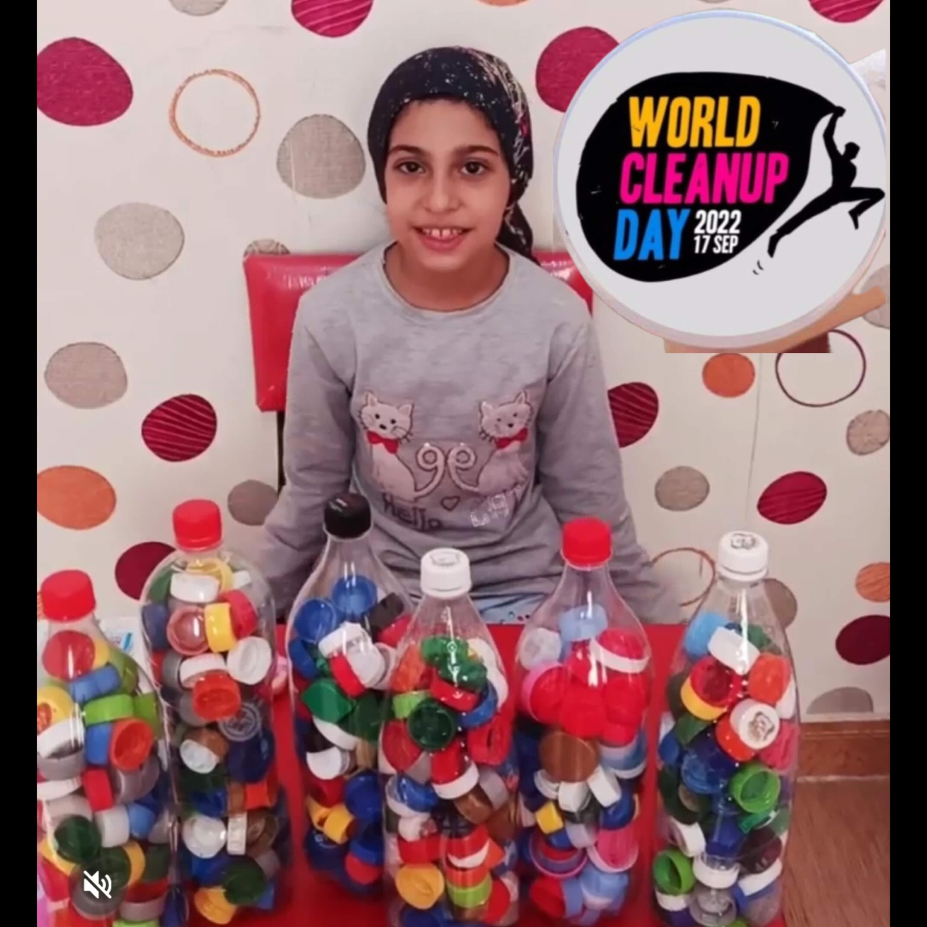 Photograph of the young ambassador for the environment, Baran Fateminejad, from Iran, age 9, showcasing all the plastic bottle caps she gathered during the event "World Cleanup Day 2022, 17 September)